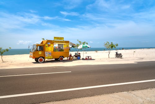 Free Photo Of Yellow Truck Beside Highway Stock Photo