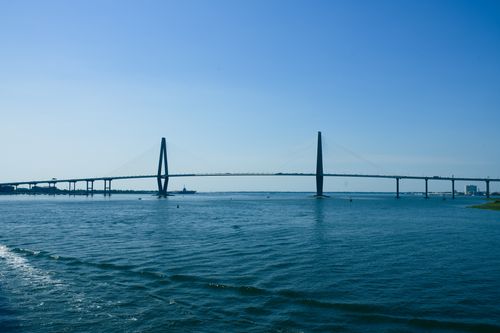 Free Scenic view of the Arthur Ravenel Jr. Bridge over calm blue waters under a clear sky. Stock Photo