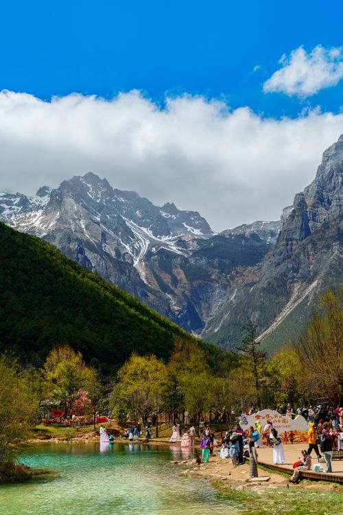 Free Tourists enjoy the stunning landscape at Jade Dragon Snow Mountain and Blue Moon Valley. Stock Photo