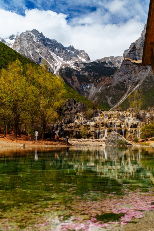 Free Pristine spring view of Baishui Terrace with clear waters and mountains. Stock Photo
