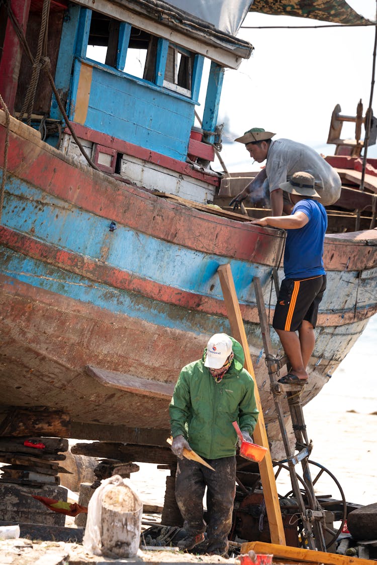 Asian Fishermen Working On Fishing Boat