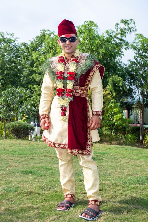 Free Man in traditional wedding attire standing outdoors on a sunny day. Stock Photo