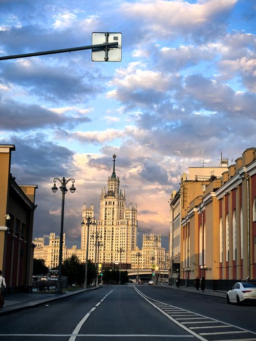 Free City view of a skyscraper in Moscow with a dramatic sunset sky, highlighting iconic architecture. Stock Photo