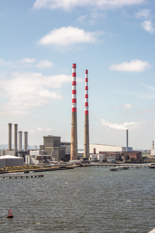 Free View of the iconic Poolbeg power station chimneys by the bay in Dublin, Ireland. Stock Photo