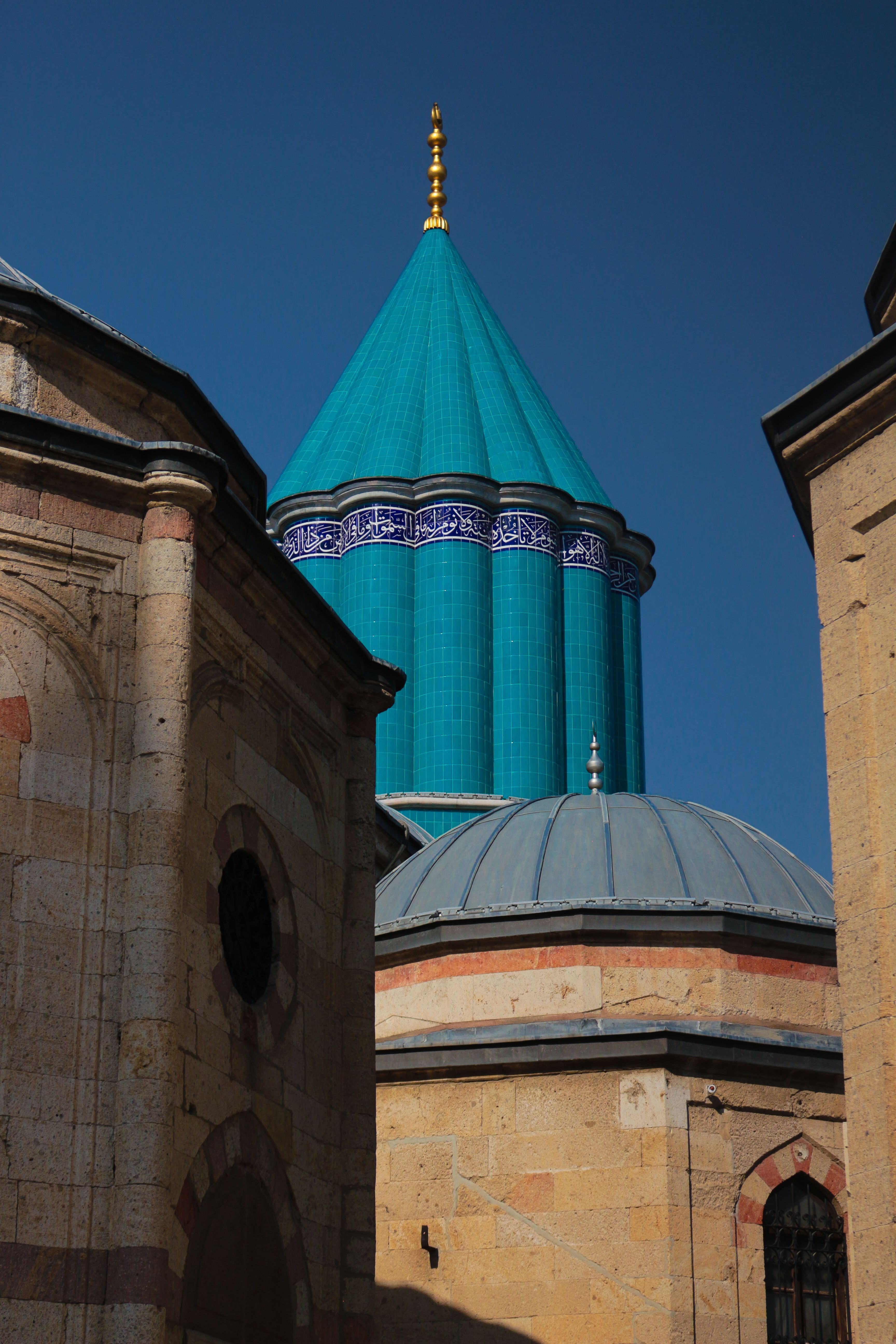 Mevlana Museum's iconic turquoise dome against the clear blue sky in Konya, Turkey.