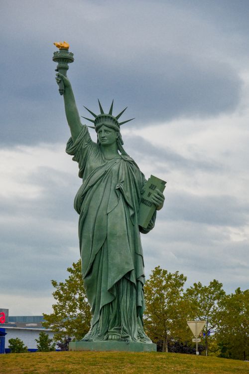 Free A replica of the Statue of Liberty under a cloudy sky in Colmar, France. Stock Photo