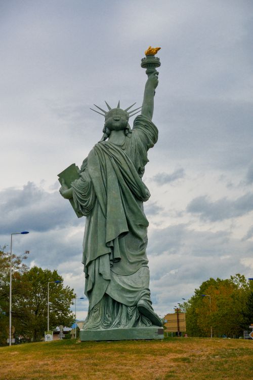 Free A detailed view of the Statue of Liberty replica located in Colmar, France, under a cloudy sky. Stock Photo