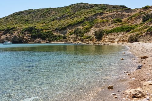 Free Discover the tranquil beauty of a pebble beach cove in Sığacık, İzmir, Türkiye, perfect for a summer getaway. Stock Photo