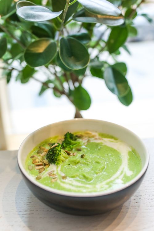 Free Delicious creamy broccoli soup garnished with seeds, a healthy meal option. Stock Photo