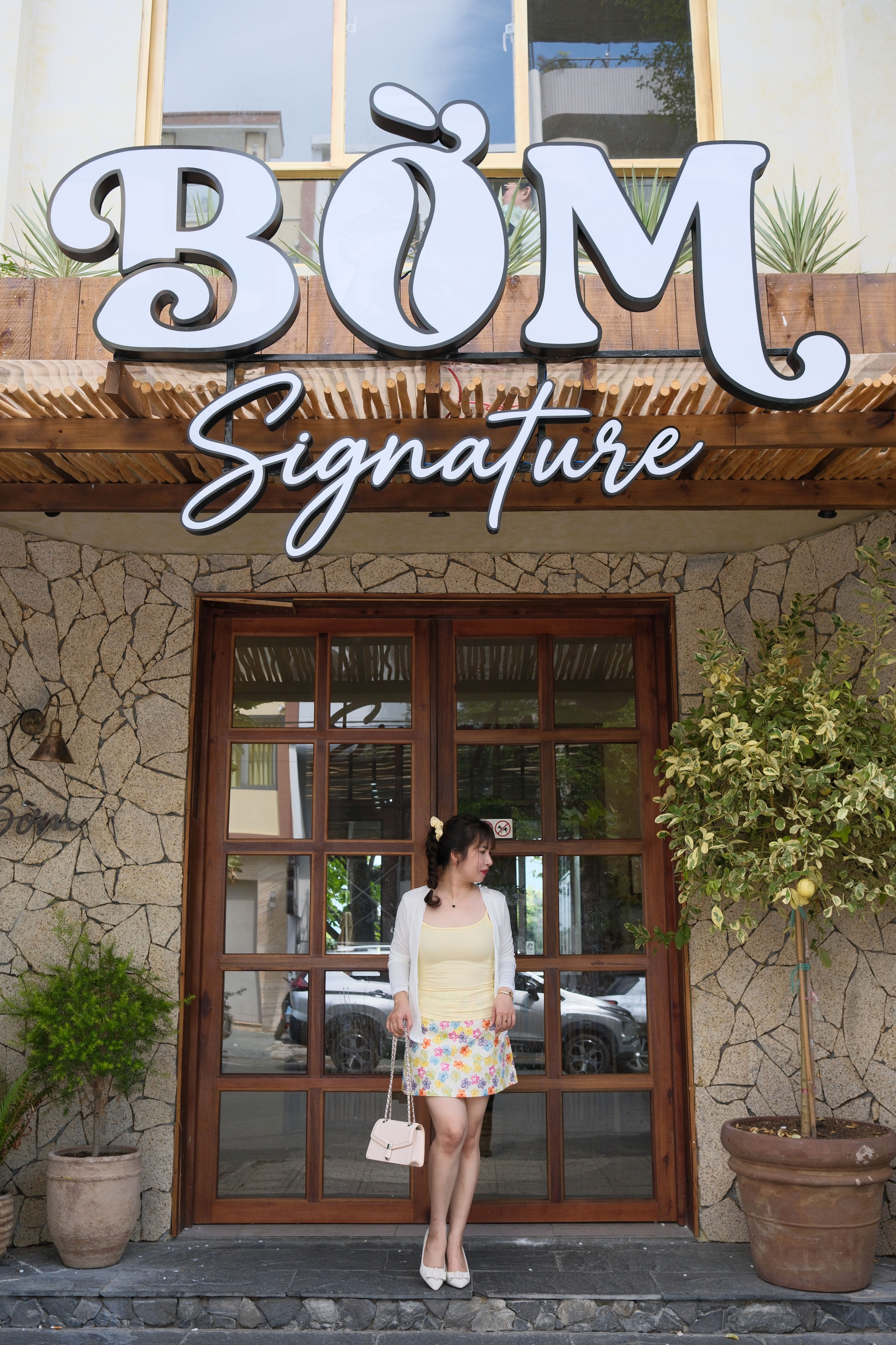 Young Woman Standing Outside BOM Signature Cafe