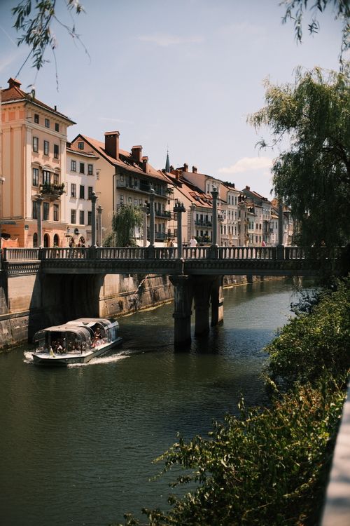 Free Charming river scene with a bridge and historic buildings in a picturesque location. Stock Photo