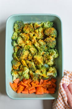 Healthy roasted broccoli and carrots in a baking tray, perfect for nutritious meals.
