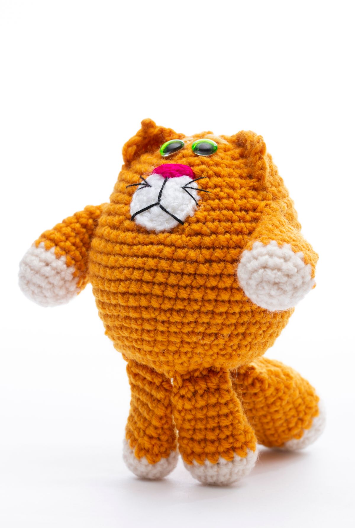 Cute crocheted orange cat plush toy, crafted with skillful amigurumi technique.