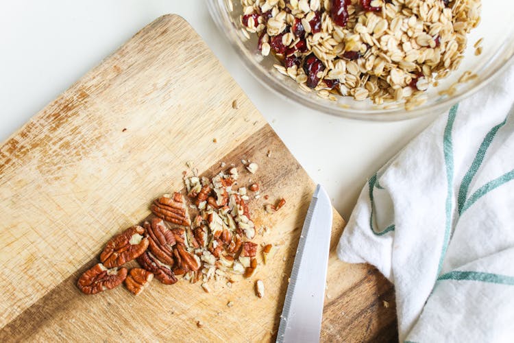 Photo Of Chopped Pecans On Wooden Chopping Board