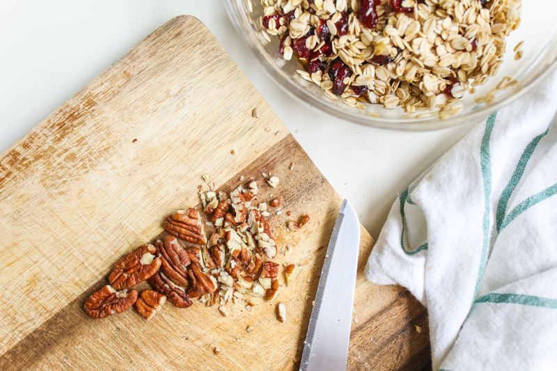 golden granola clusters on a sheet pan with pecans