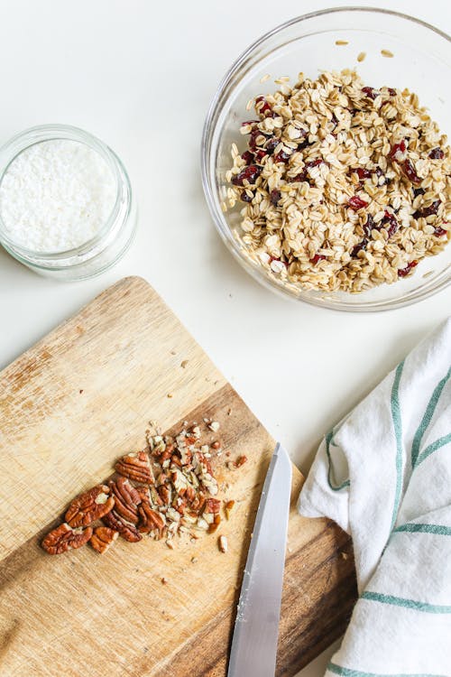 Photo Of Chopped Pecans On Wooden Chopping Board