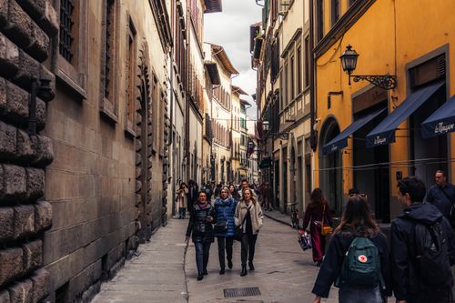 Free Bustling street in Florence, Italy, with historical architecture and people walking. Stock Photo