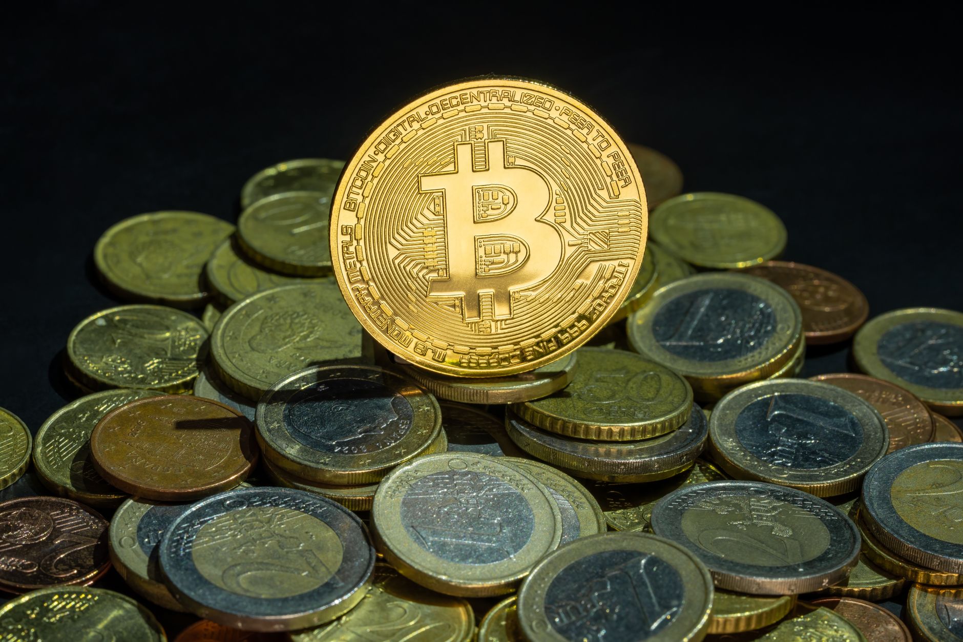 Close-up view of Bitcoin and Euro coins, symbolizing digital and traditional finance.