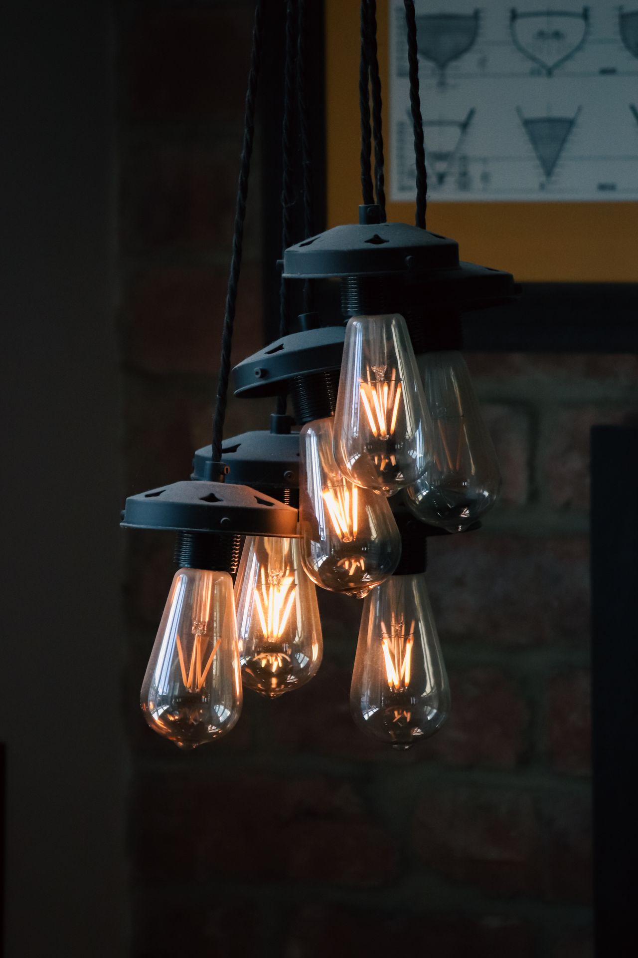 Cluster of vintage Edison bulbs glowing warmly against a dark background