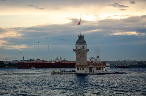 Free Beautiful sunset at Maiden's Tower, Istanbul with a striking skyline and calm waters. Stock Photo