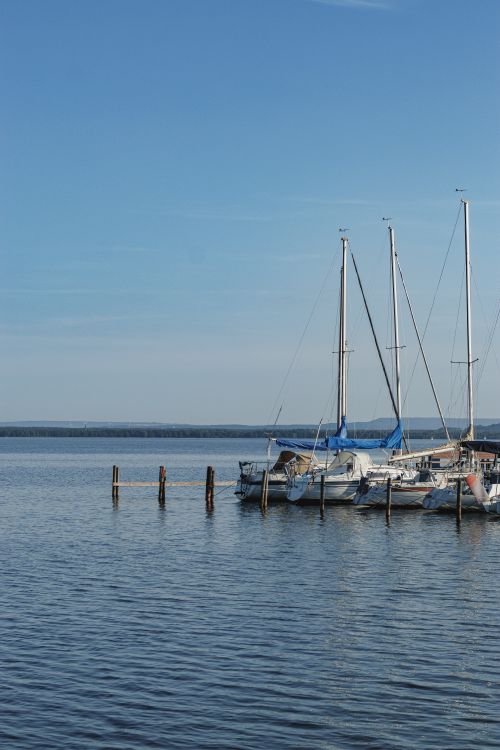Free Calm waters reflecting sailboats at a serene harbor in Wunstorf, Germany. Stock Photo