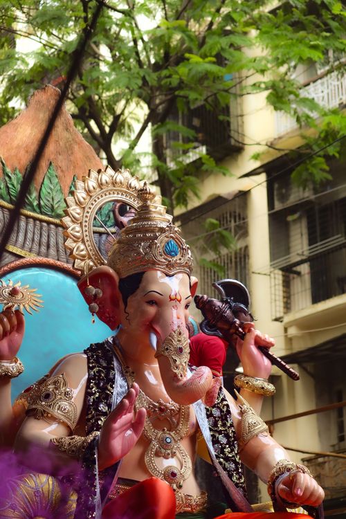 Free Vibrant Ganesh statue in a street festival parade, showcasing detailed craftsmanship. Stock Photo