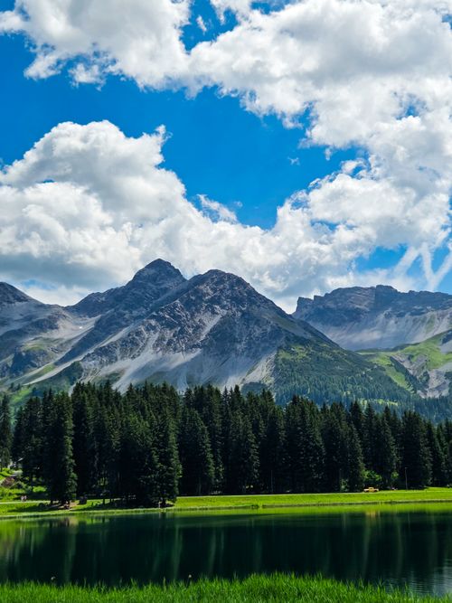 Free A breathtaking view of alpine mountains and a serene lake in Arosa, Switzerland. Stock Photo