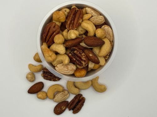 Mixed nuts in a clear tub on a white surface — photo by Ilona Jurtschenko-Roelofs on Pexels