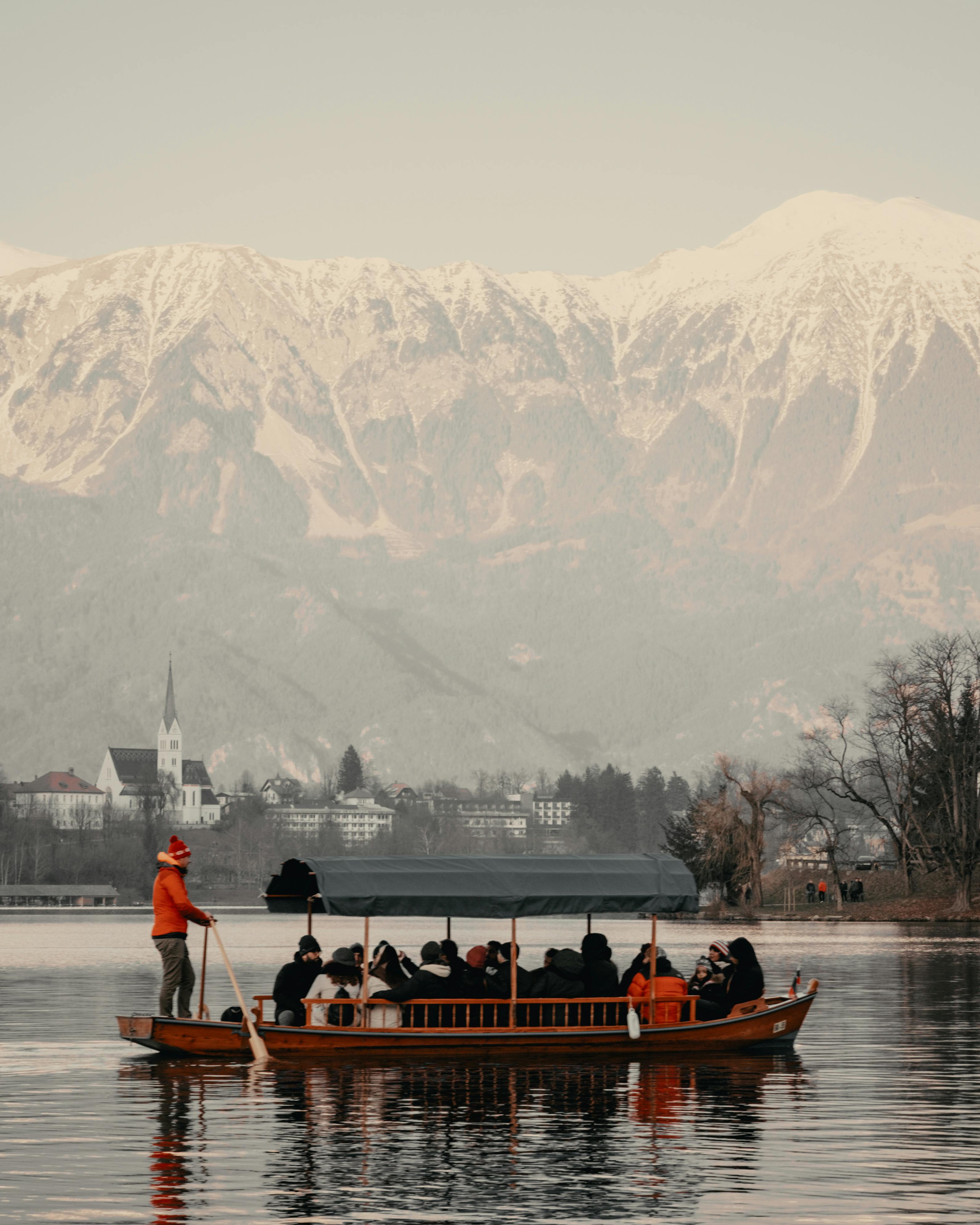 Free A serene boat ride on Lake Bled, Slovenia with snow-capped mountains in the background. Stock Photo