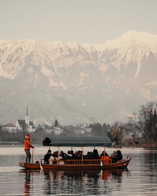 People Riding a Boat on the Lake