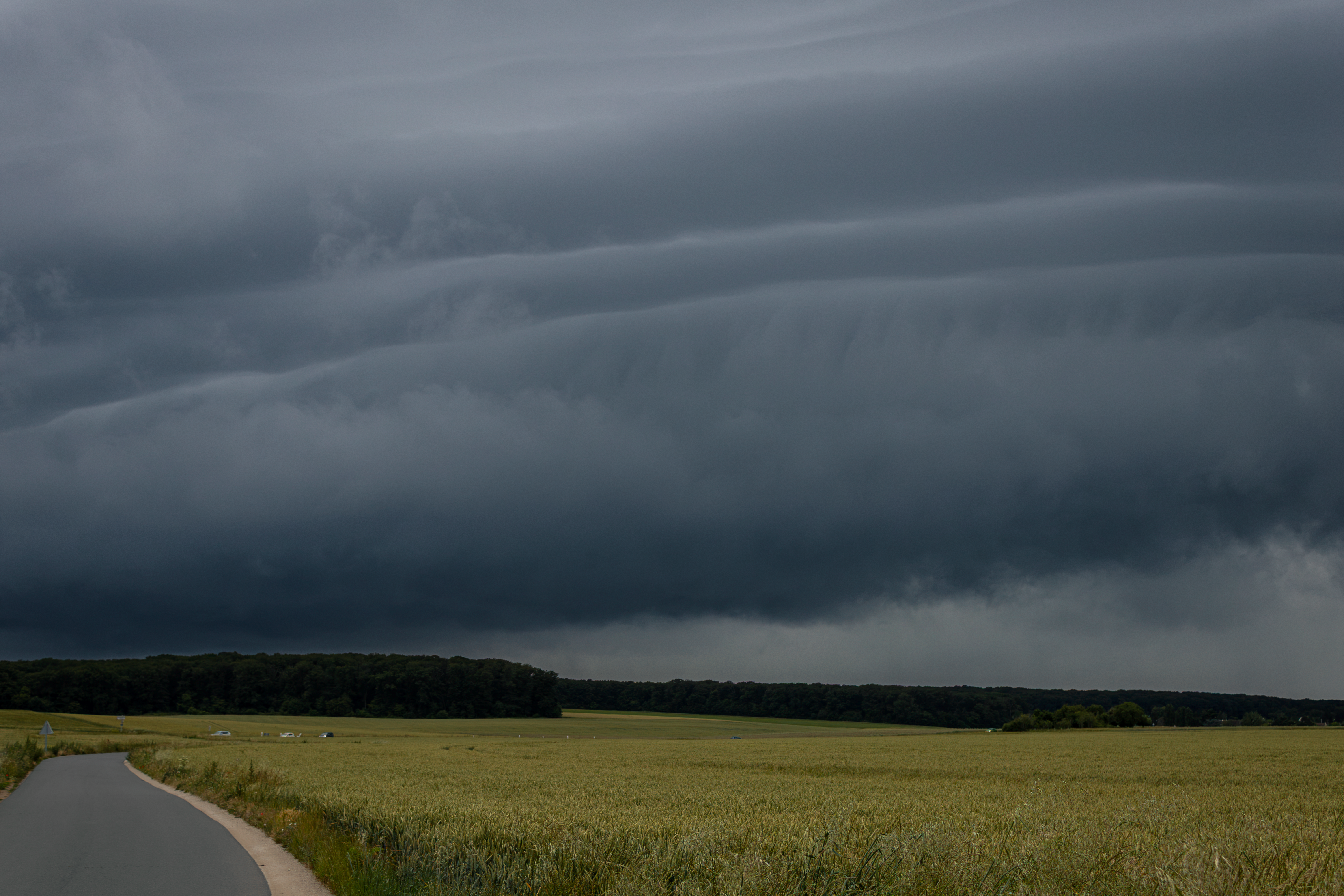 Captivating image of threatening storm clouds over a rural countryside landscape.