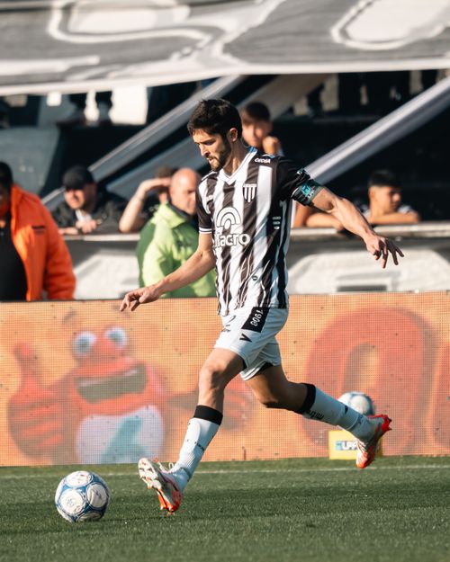 Free A soccer player skillfully dribbles the ball on the field during a competitive match, showcasing agility and focus. Stock Photo