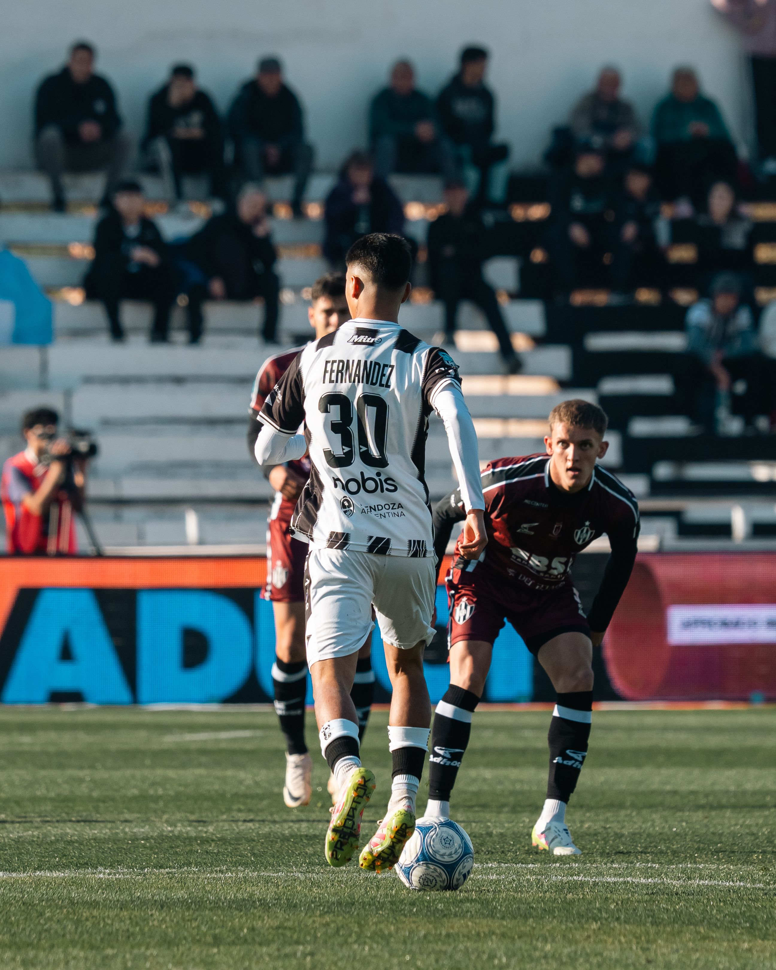 Intense soccer game action between two players captured on the field.
