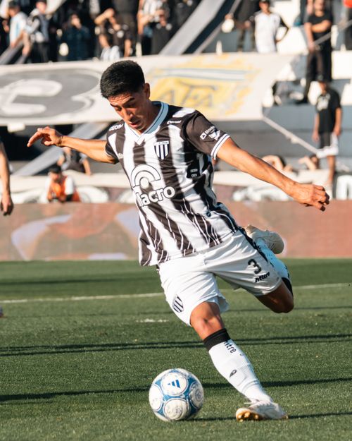 Free A soccer player powerfully kicking a ball during a match on a sunny day. Stock Photo