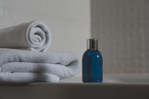 Free Blue Glass Bottle Beside White Towel Stock Photo