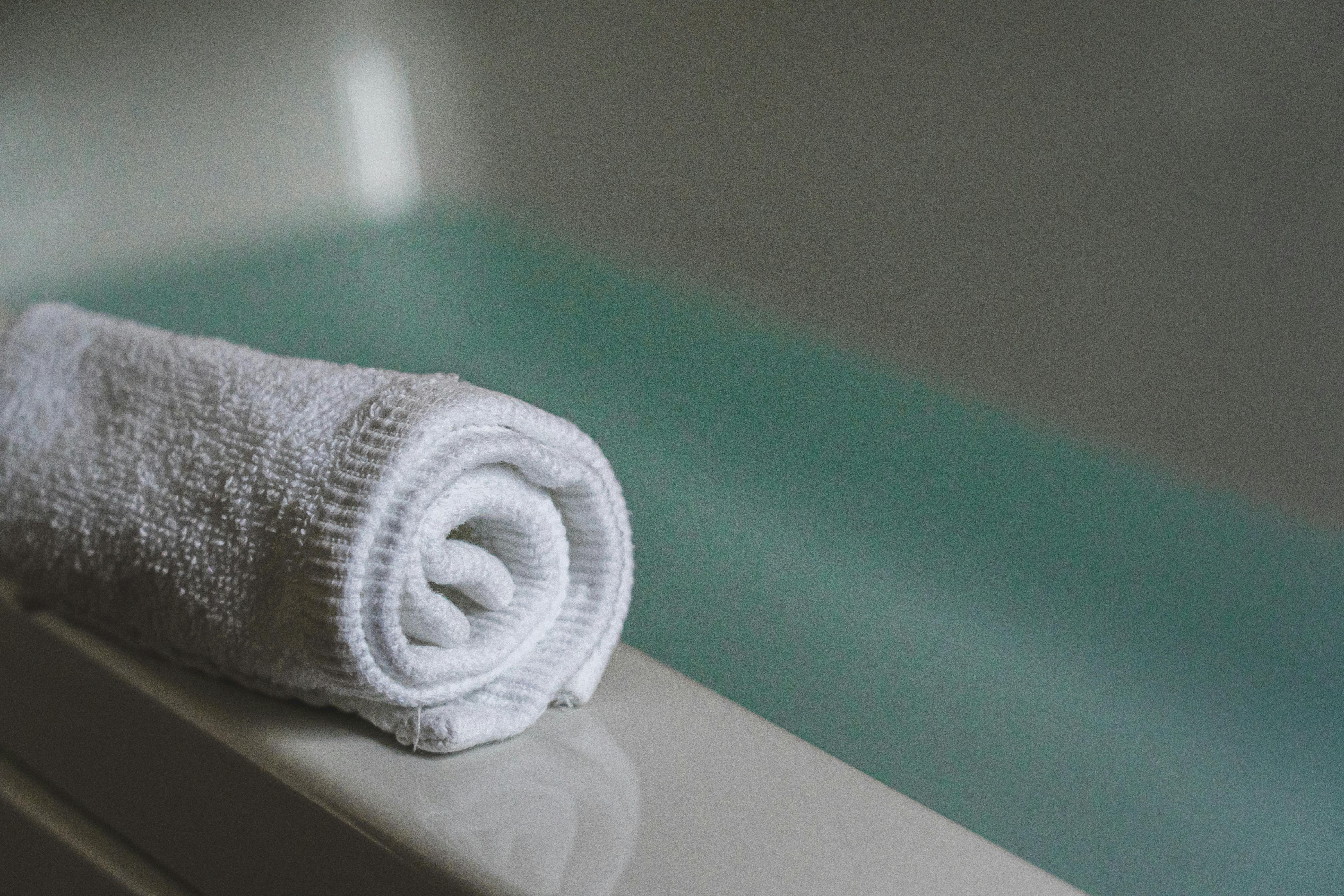 Bath Towel on the Bathtub · Free Stock Photo