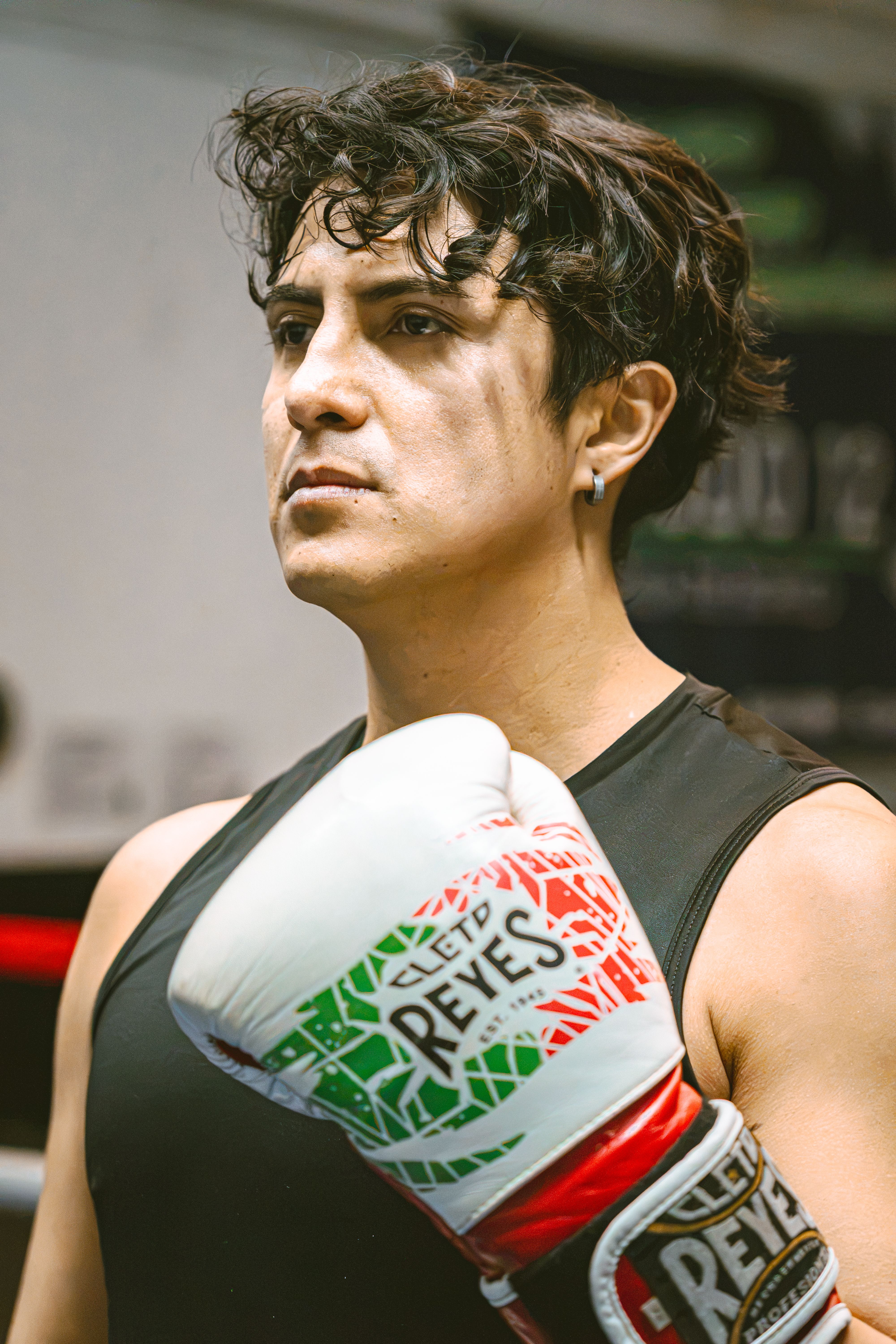 Determined boxer in the gym with gloves, ready for a championship fight.
