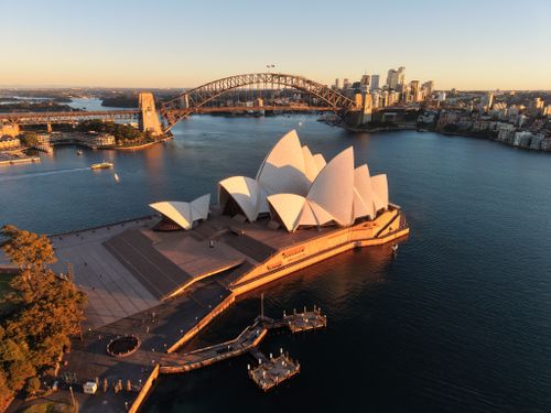Free Beautiful aerial view of Sydney Opera House and Harbor Bridge at sunrise. Stock Photo