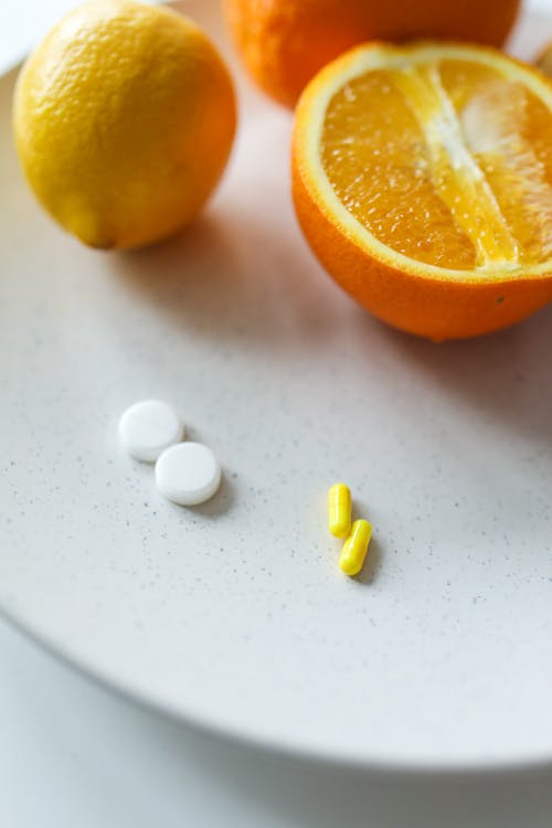 Free Photo Of Pills Beside Orange Stock Photo
