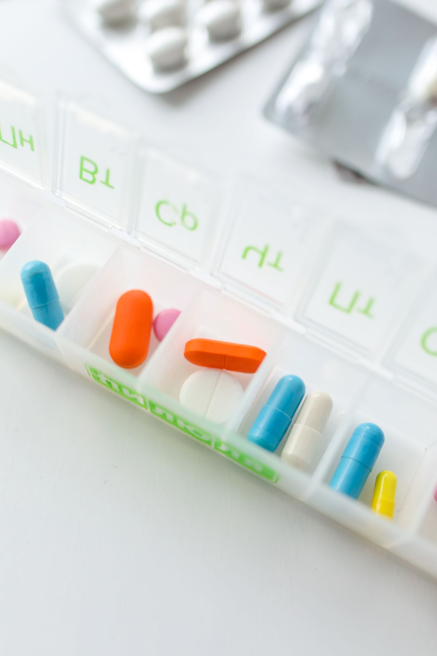 Tablets arranged in a weekly medication organizer