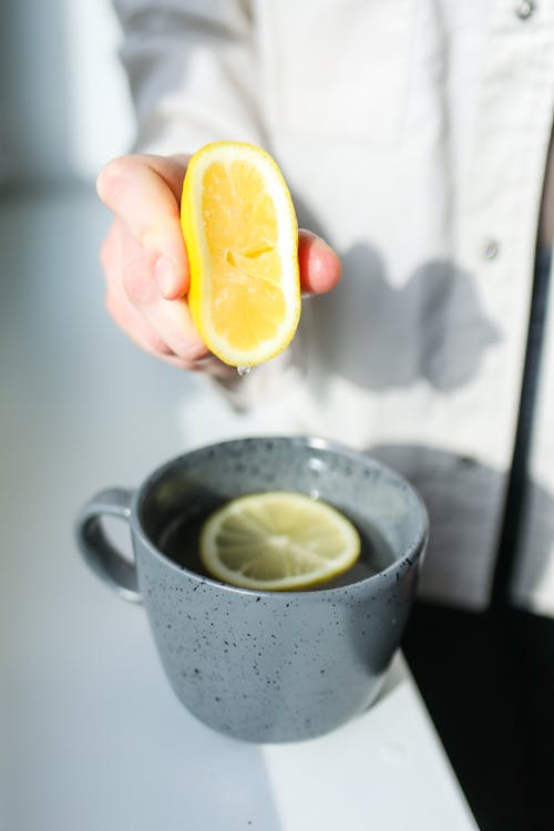 Photo of Person Squeezing Lemon