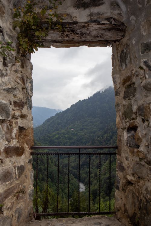 Free A scenic view through Zilkale castle window showcasing a lush valley in Türkiye. Stock Photo