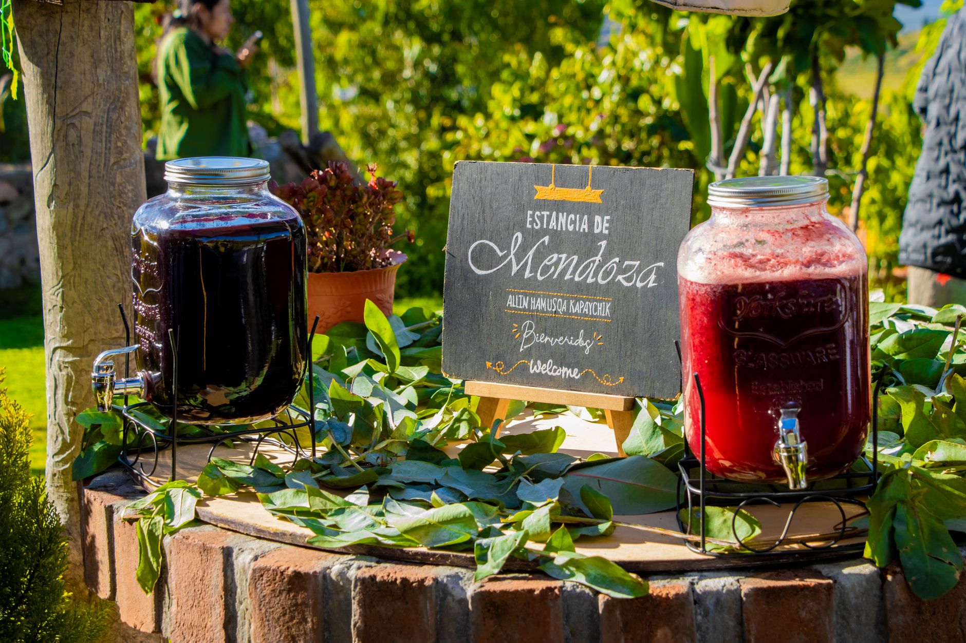 Outdoor beverage presentation at Estancia de Mendoza with natural juice jars in Ayacucho, Peru.
