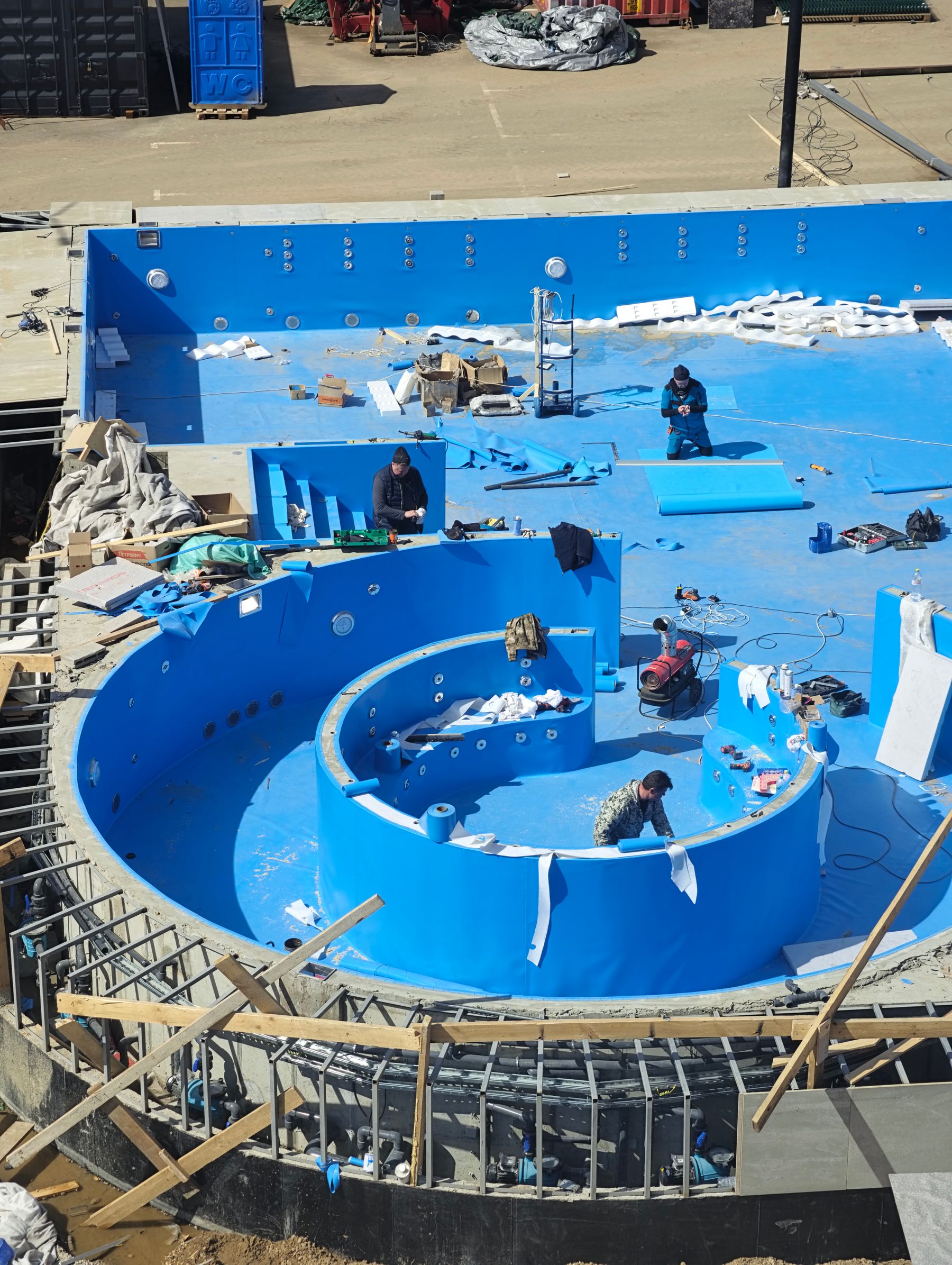 Pool construction team working on a new concrete pool