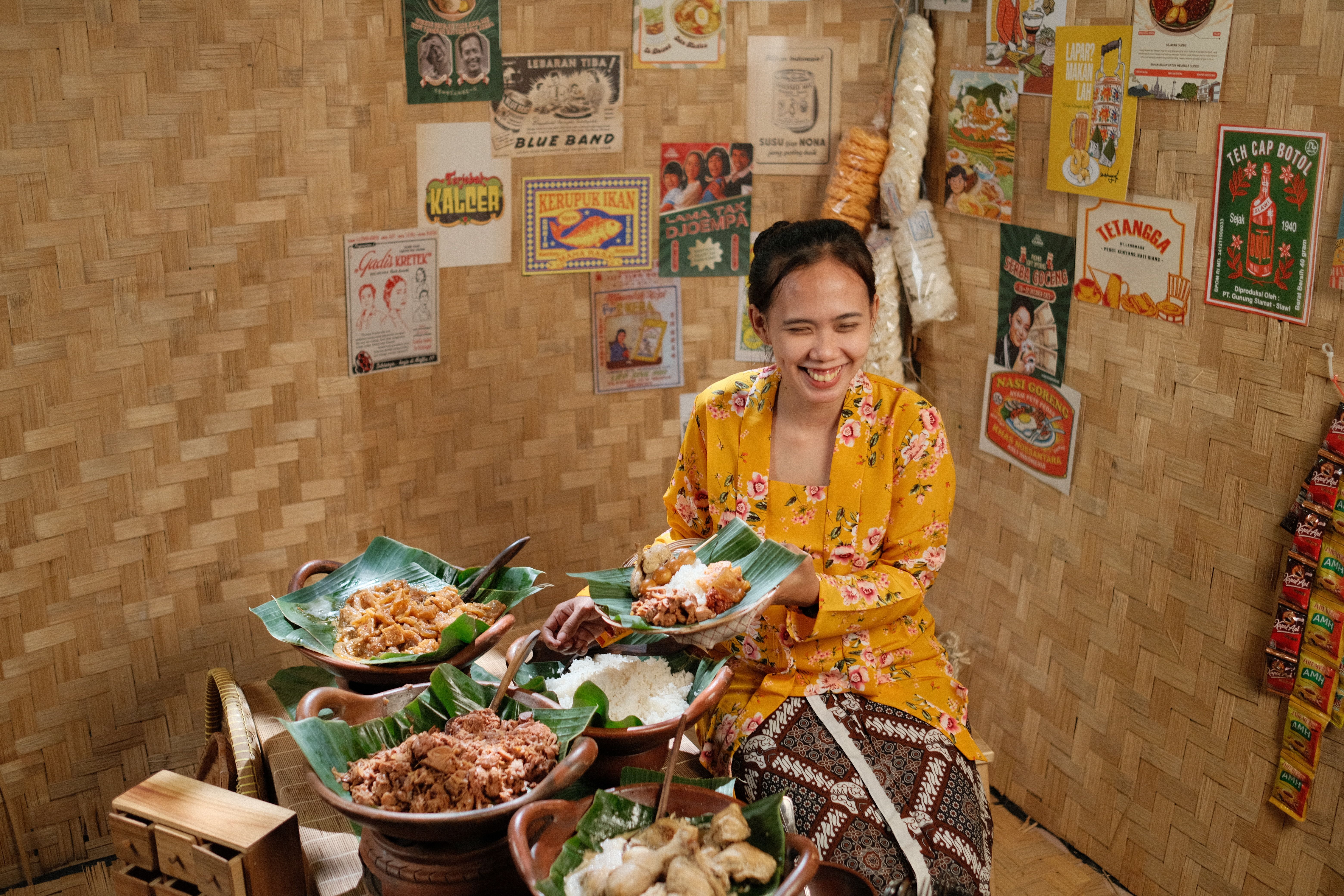 Smiling woman enjoying traditional Indonesian cuisine in a Jakarta eatery with vintage decor.