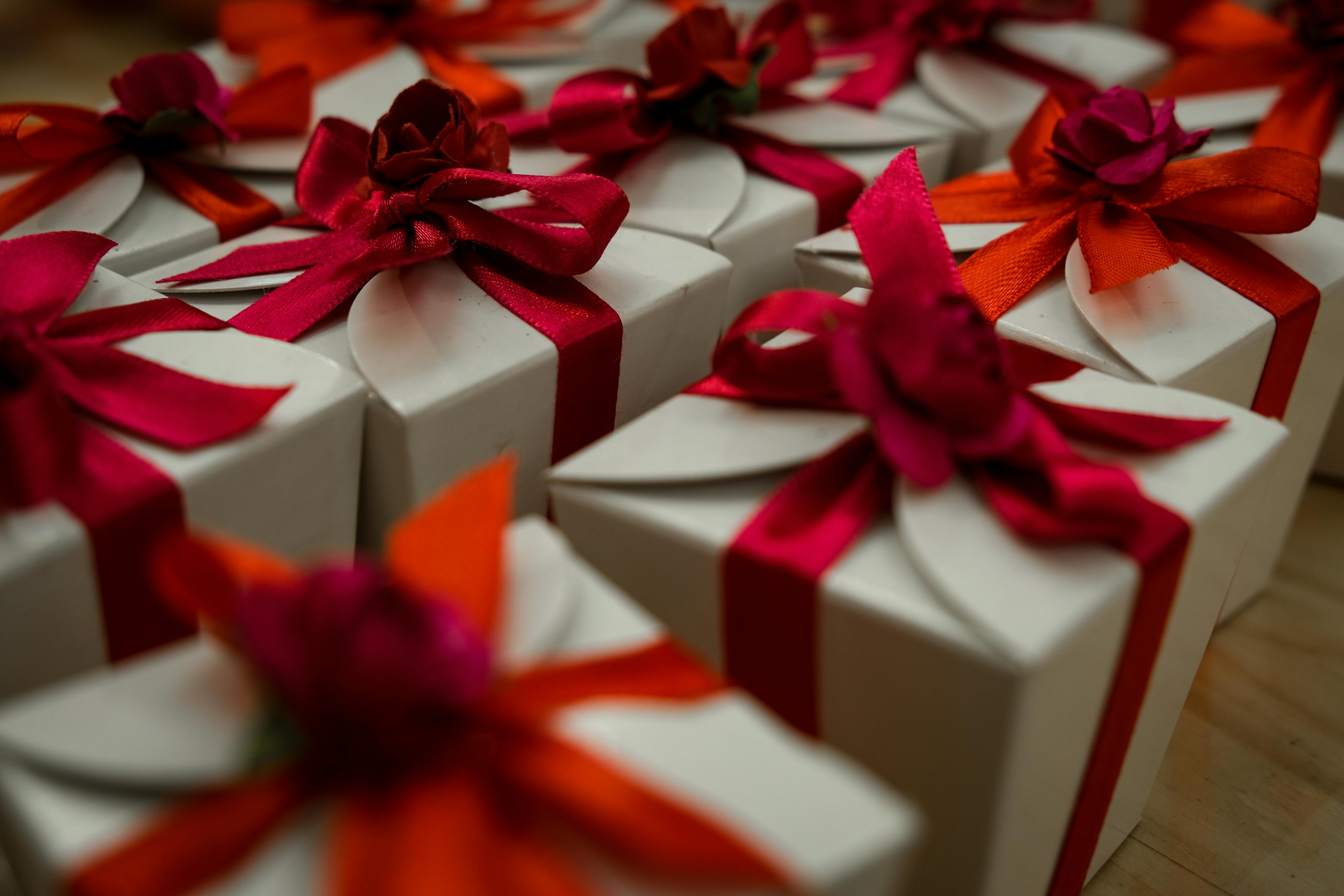 white gift boxes with red ribbon