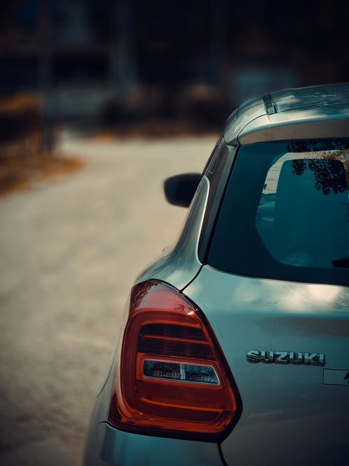 Free Close-up of a silver car parked on a quiet street, captured during daytime. Stock Photo