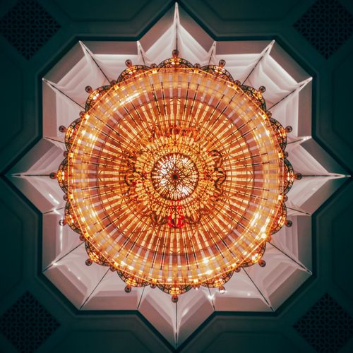 Free Captivating view of a golden chandelier in a decorative ceiling in Algiers, Algeria. Elegant and intricate design. Stock Photo