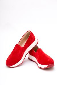 Red suede slip-on sneakers on a white background — photo by Valentin Ivantsov on Pexels