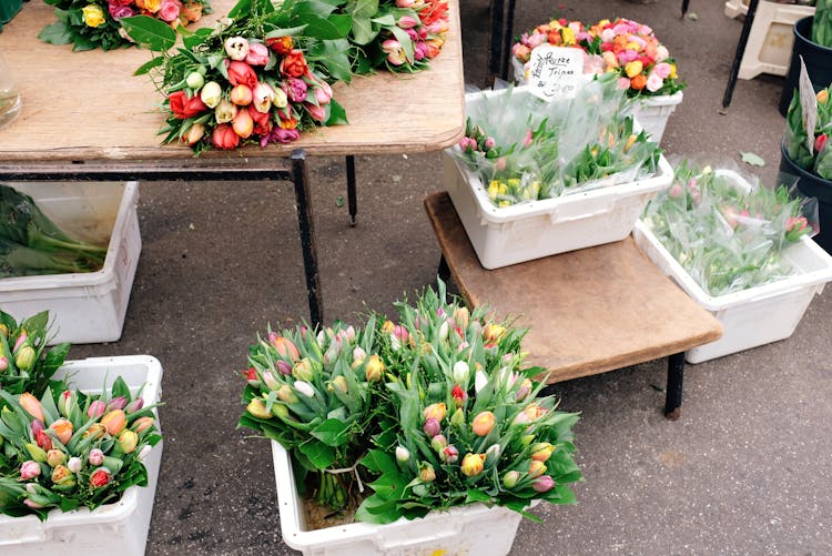 Containers With Fresh Flowers On Stall In Street Market